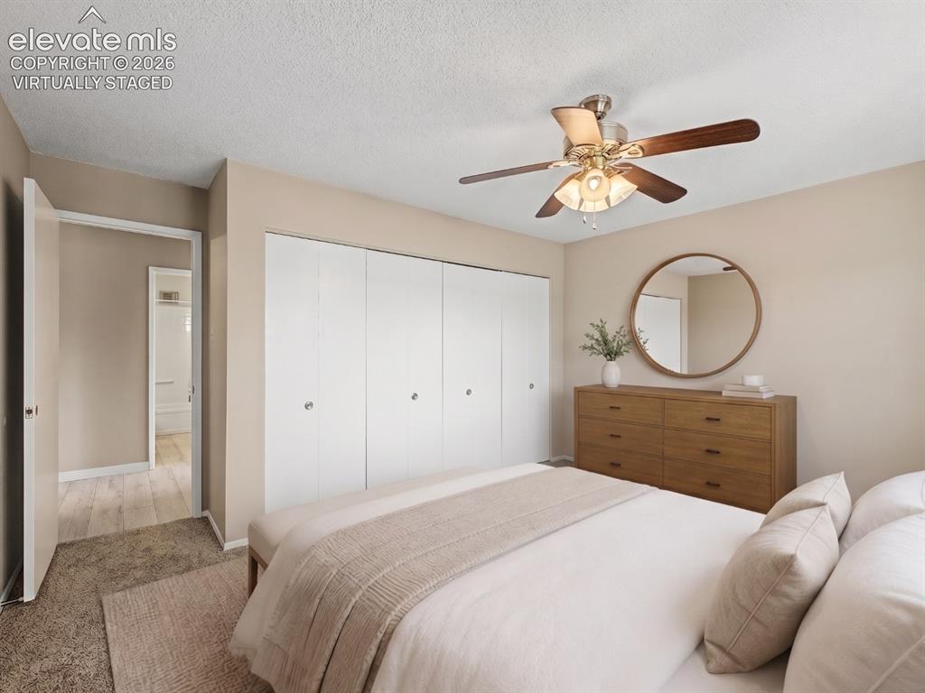 Image 15 of 50: virtually staged Bedroom featuring carpet flooring, a multi-blade ceiling f