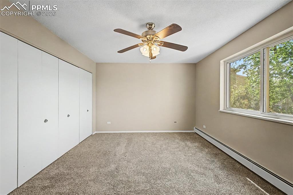 Image 16 of 42: Room with neutral-toned carpeting and light beige wall paint