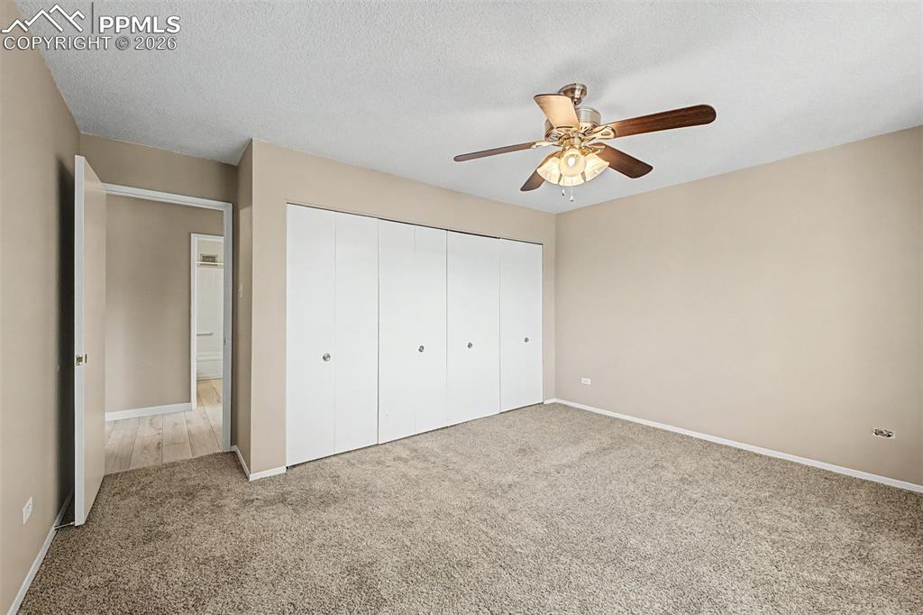 Image 17 of 42: Spacious room featuring neutral carpeting and light beige wall paint