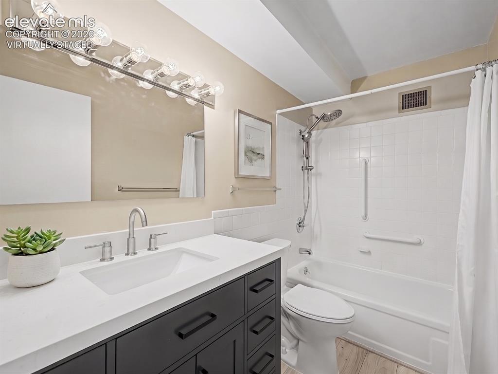 Image 18 of 50: virtually staged Modern bathroom featuring a dark wood-finish vanity with a