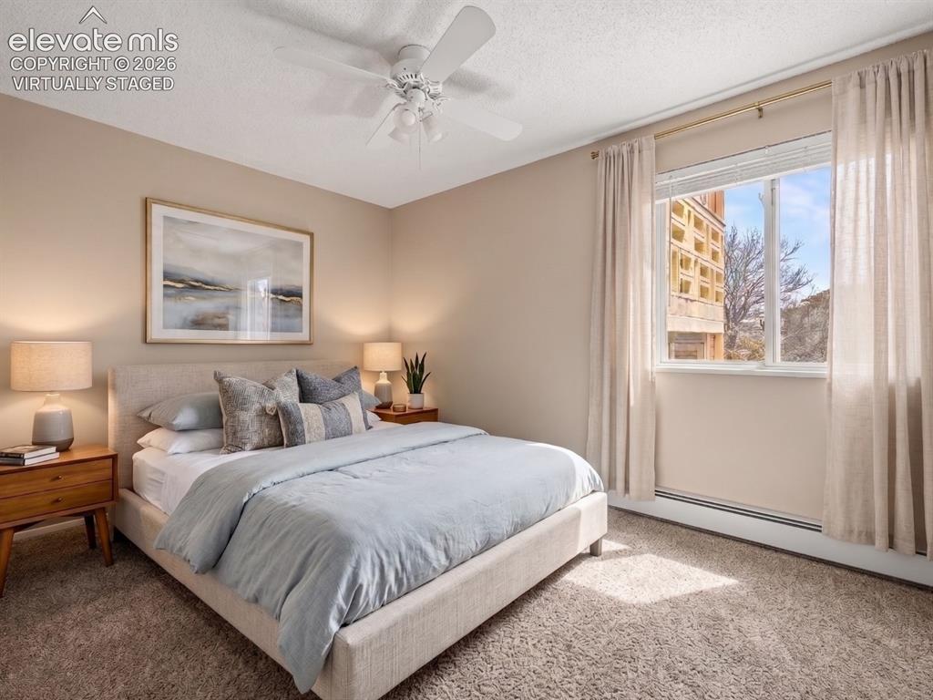 Image 20 of 50: virtually staged Carpeted room with a ceiling fan and large window