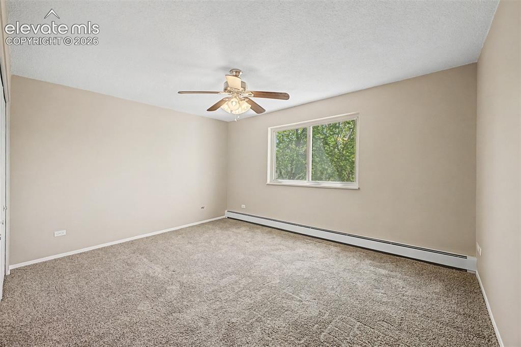 Image 21 of 50: Neutral-toned carpeted room with light beige walls