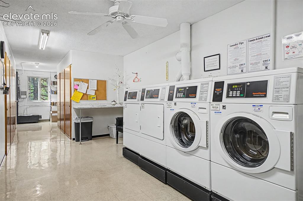 Image 30 of 50: Dedicated laundry facility featuring multiple commercial-grade washers and