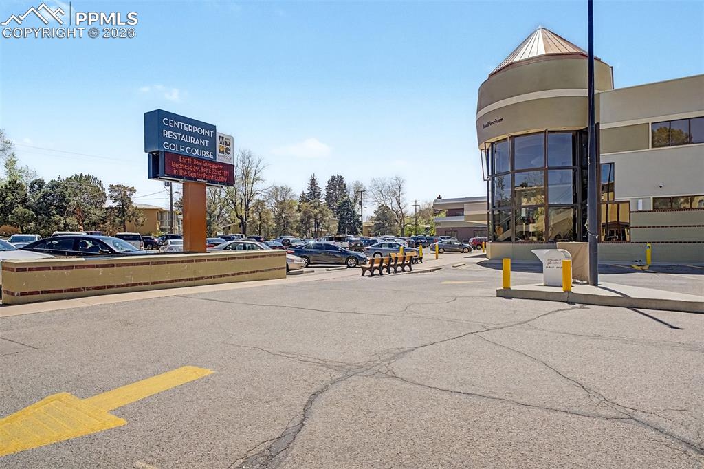 Image 38 of 42: Large surface parking lot with a prominent signage display