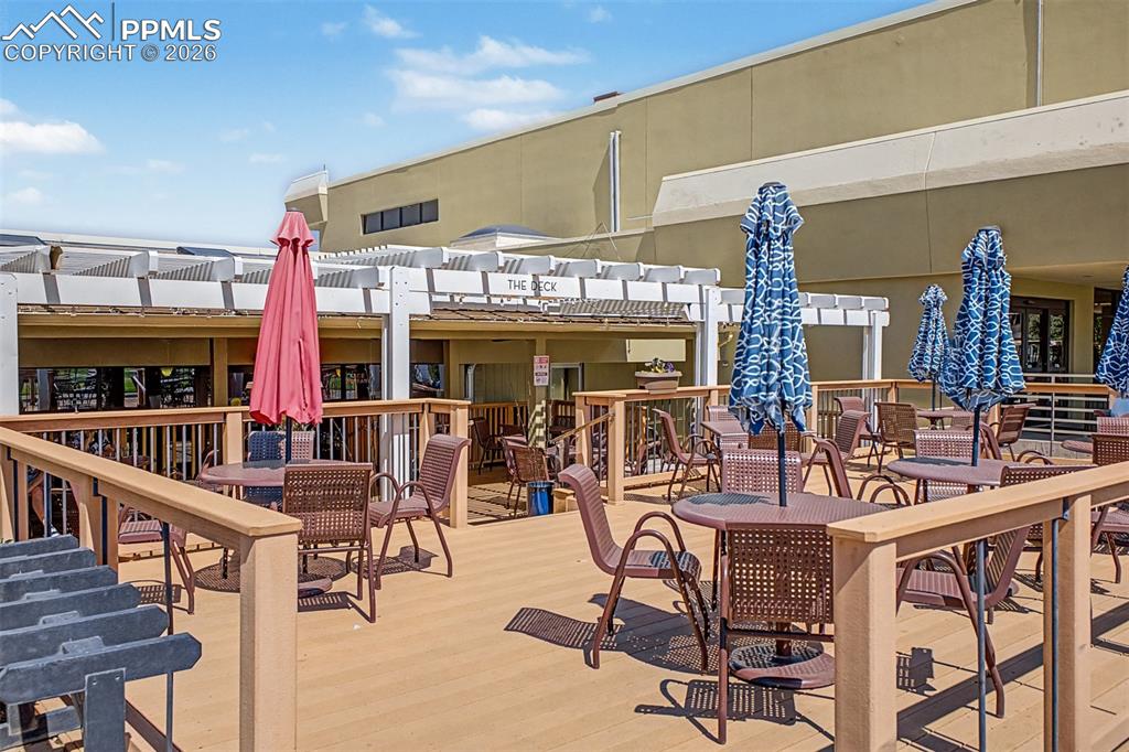 Image 39 of 42: Expansive outdoor deck featuring composite wood-finish flooring, a white pe