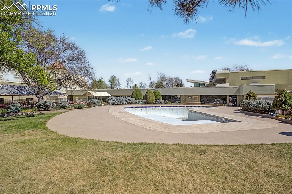 Image 41 of 42: Expansive outdoor space featuring a kidney-shaped pool, concrete patio, and