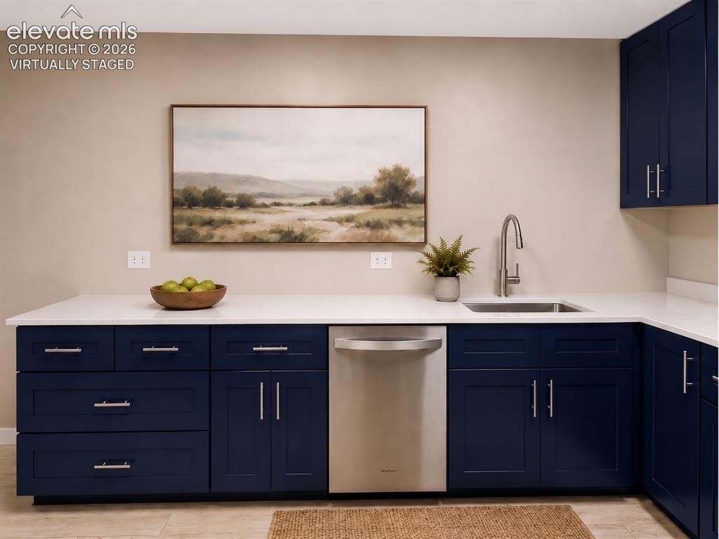 Image 6 of 50: virtually staged L-shaped countertop featuring an undermount stainless stee