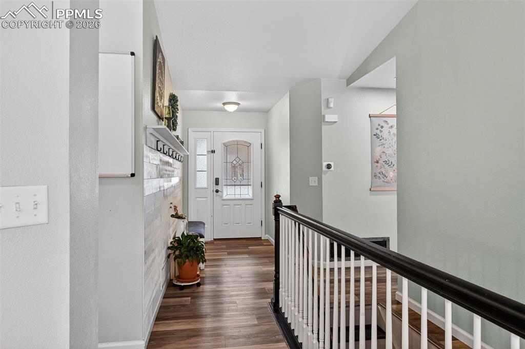 Image 10 of 47: Entrance foyer featuring baseboards and dark wood-style flooring