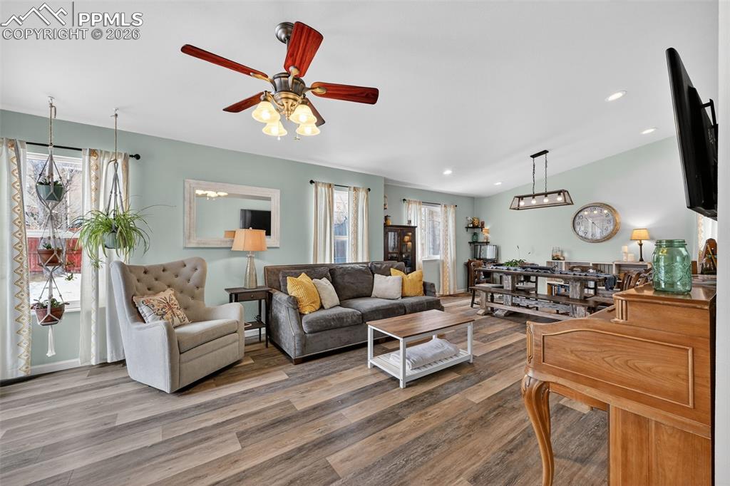 Image 12 of 47: Living area featuring plenty of natural light, wood finished floors, ceilin