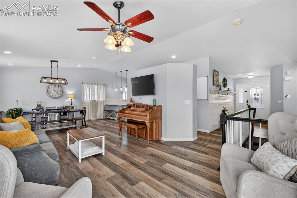Image 13 of 47: Living area with a ceiling fan, wood finished floors, and recessed lighting