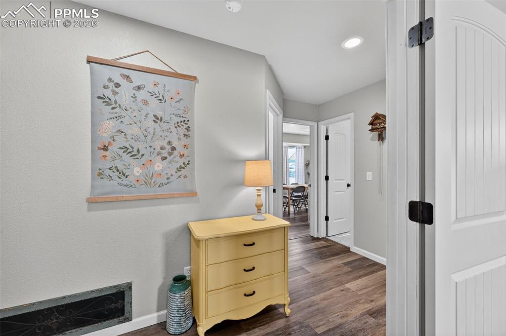 Image 27 of 47: Hallway featuring dark wood-style flooring and recessed lighting