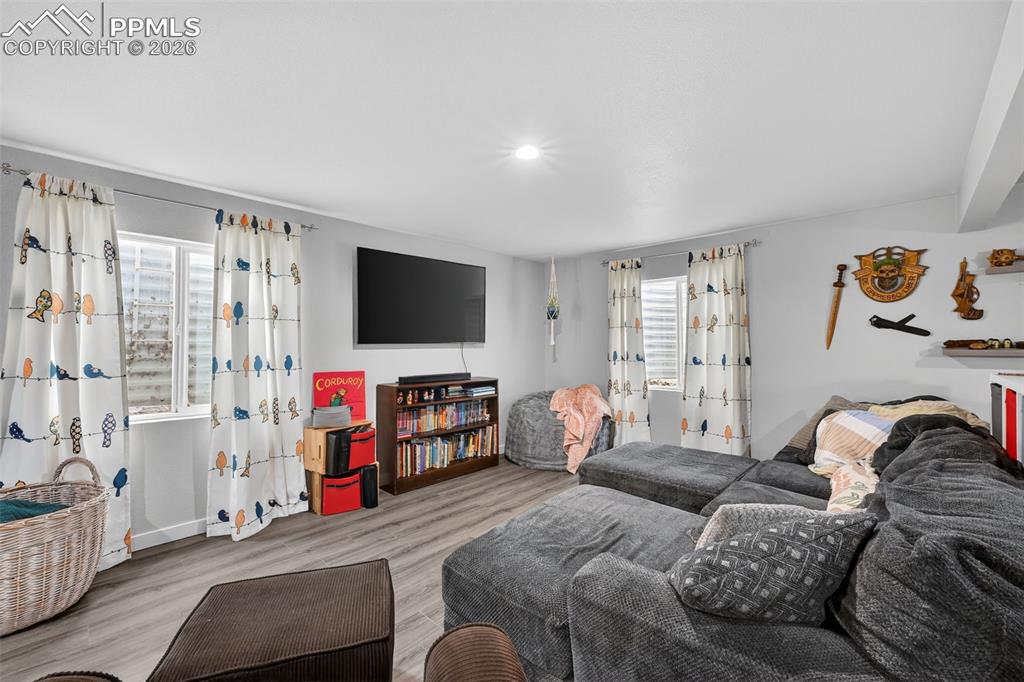 Image 35 of 47: Living room with wood finished floors and baseboards