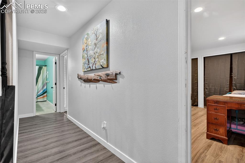 Image 38 of 47: Hallway with light wood-style floors and recessed lighting