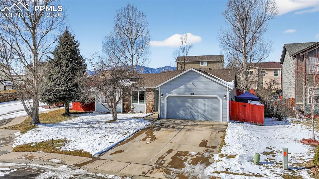 Image 4 of 47: View of front of home featuring a garage and concrete driveway