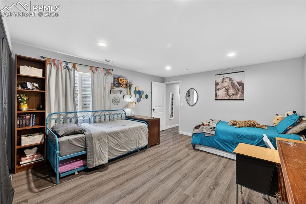 Image 40 of 47: Bedroom featuring light wood-type flooring and recessed lighting