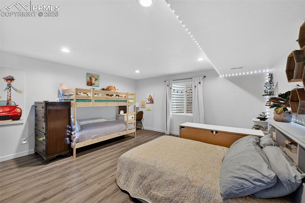 Image 42 of 47: Bedroom featuring wood finished floors and recessed lighting
