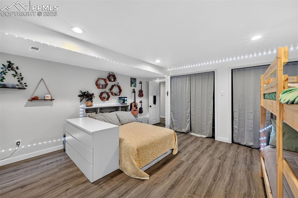 Image 43 of 47: Bedroom with multiple closets and wood finished floors