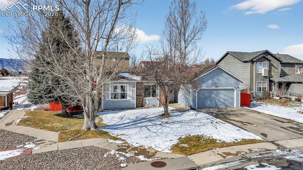Image 8 of 47: View of front of property featuring concrete driveway and a garage