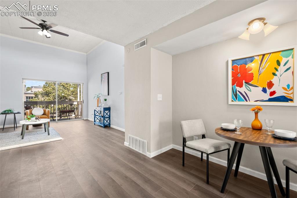 Image 10 of 27: The property features vaulted ceilings, wood flooring, and a sliding glass 