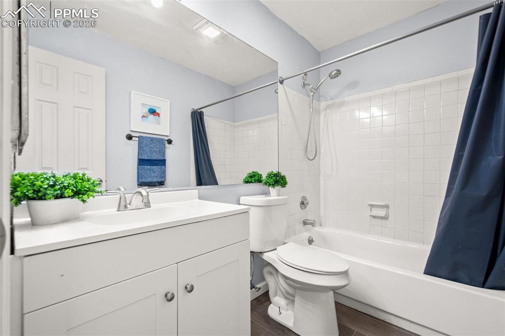 Image 20 of 27: Bathroom featuring a white vanity with a rectangular sink, a large wall-mou