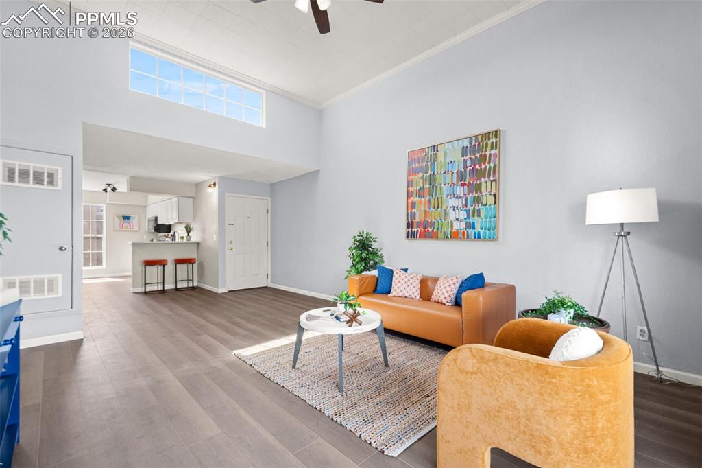 Image 8 of 27: The living area features high ceilings, a large transom window providing na