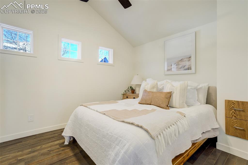 Image 15 of 35: Bedroom 1 on the main level with custom storage built-ins.