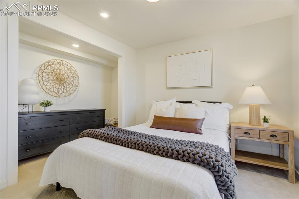 Image 24 of 35: Bedroom 3 in the basement with a closet (doors removed for convenience).