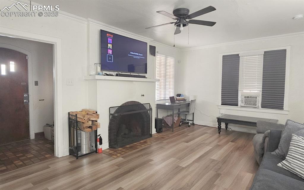 Image 5 of 28: Living Room with Wood -Burning Fireplace