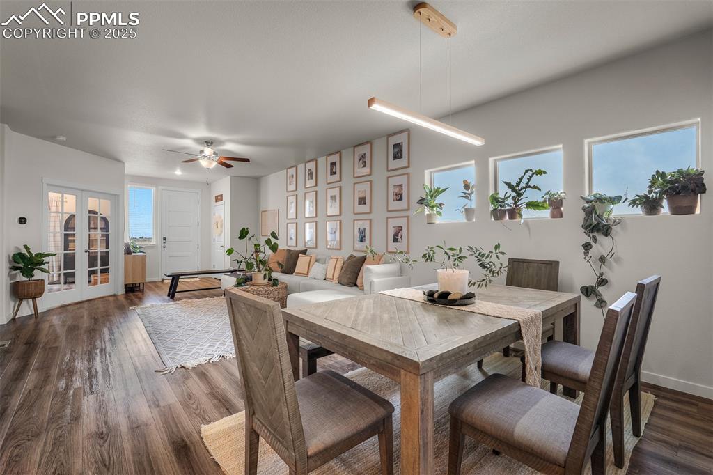 Image 10 of 49: Dining space with ceiling fan, dark wood-type flooring, french doors, and b