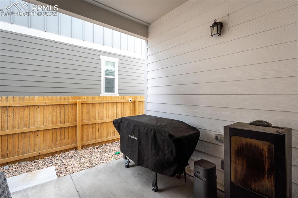 Image 18 of 49: View of patio featuring fence