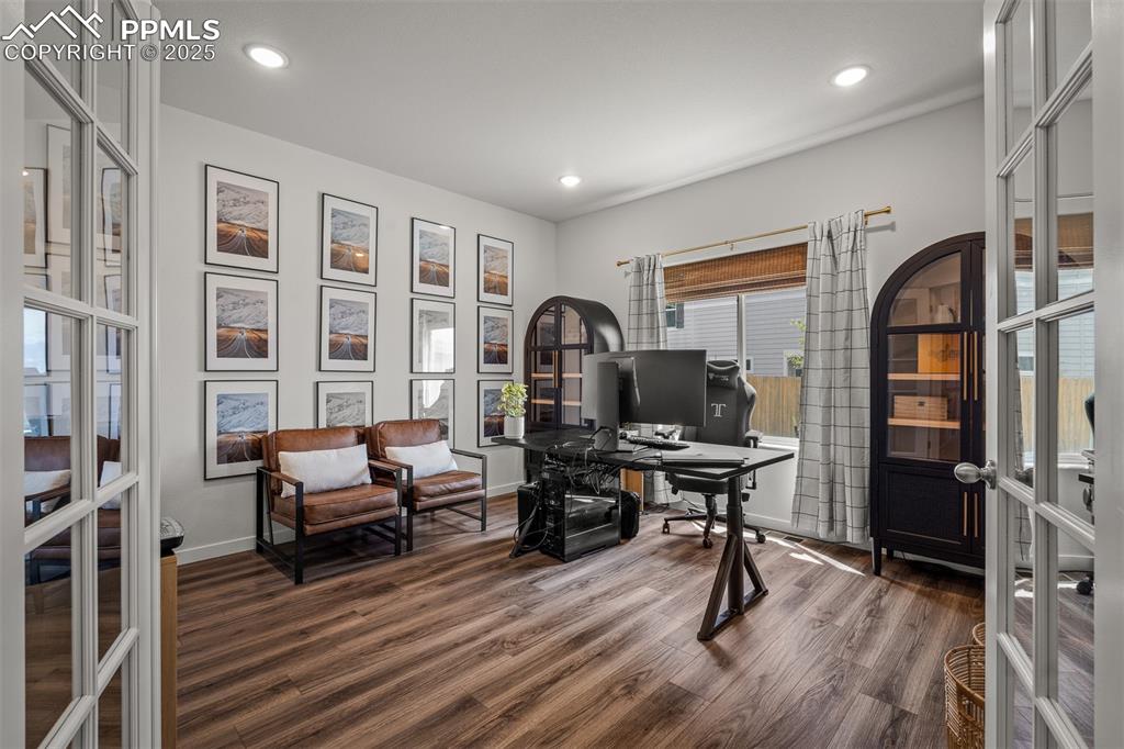 Image 21 of 49: Home office featuring dark wood-type flooring, french doors, baseboards, an