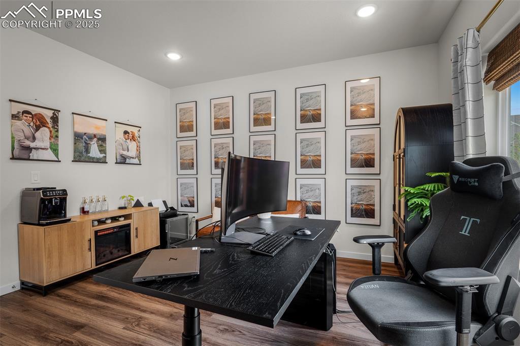 Image 22 of 49: Office space with dark wood-type flooring, baseboards, and recessed lightin