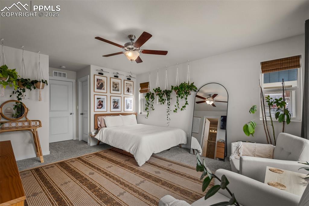 Image 24 of 49: Bedroom with carpet floors and ceiling fan