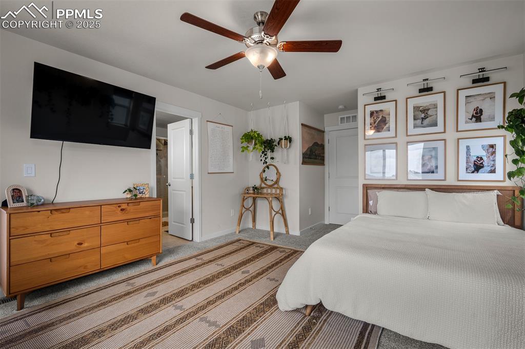 Image 26 of 49: Bedroom featuring light colored carpet, baseboards, and ceiling fan