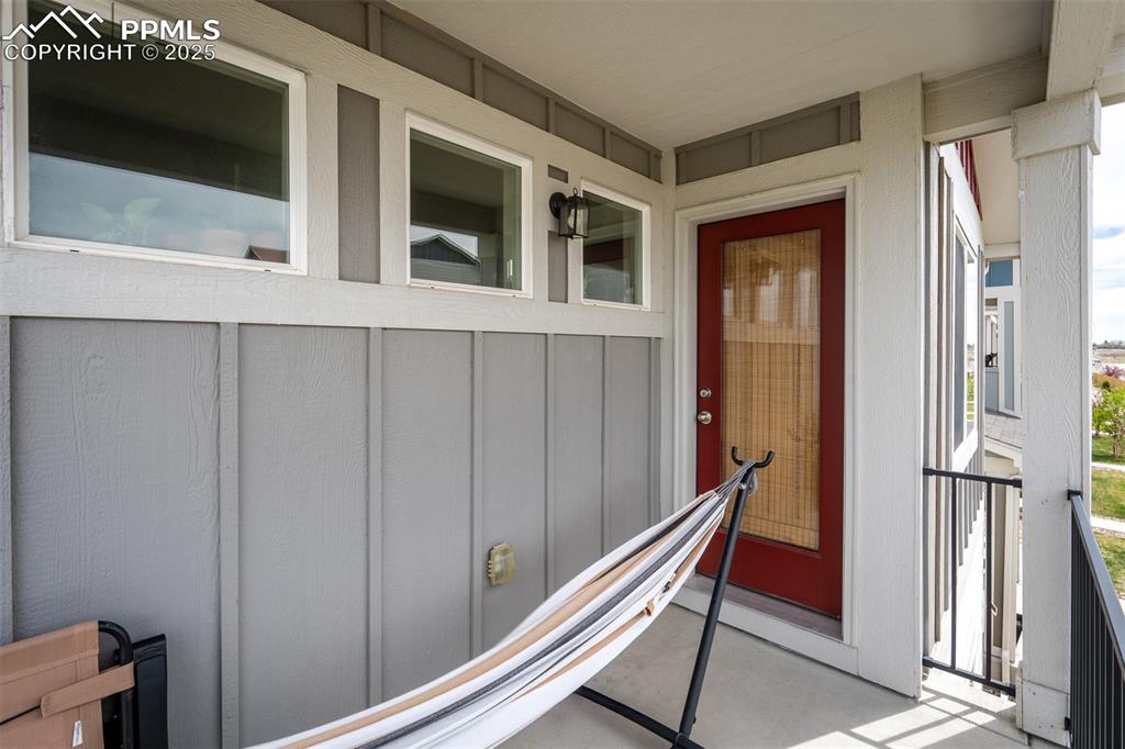 Image 29 of 49: Property entrance with board and batten siding
