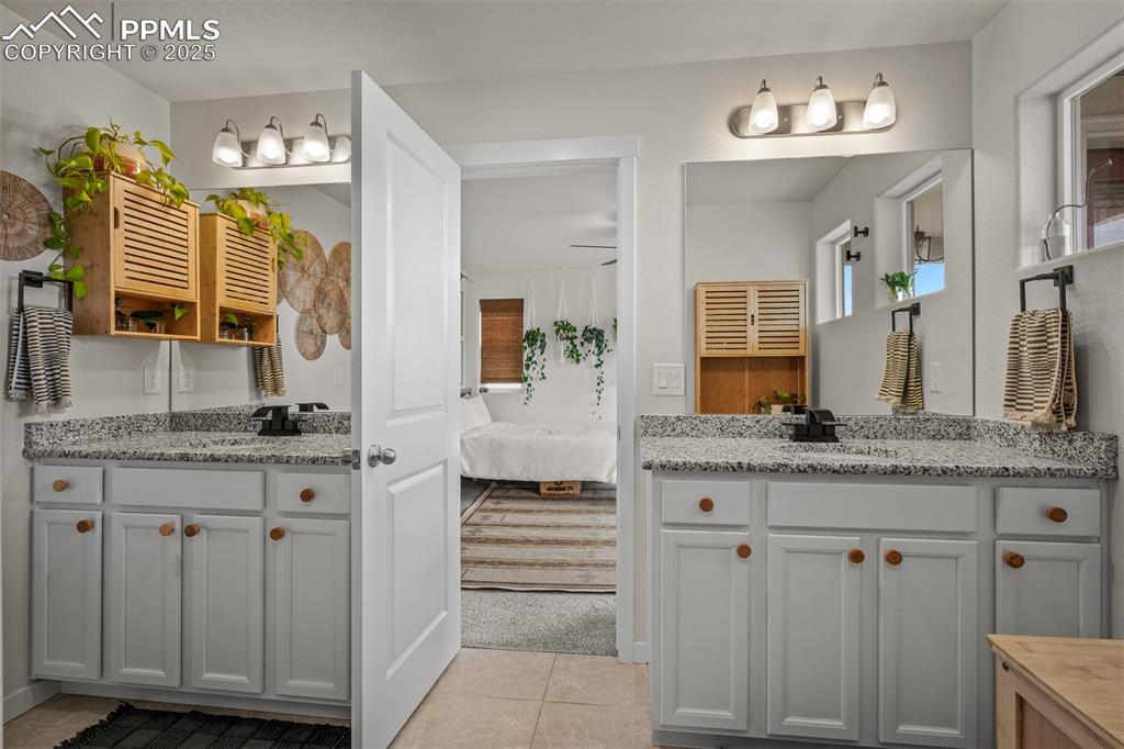 Image 30 of 49: Full bathroom featuring connected bathroom, tile patterned flooring, and tw