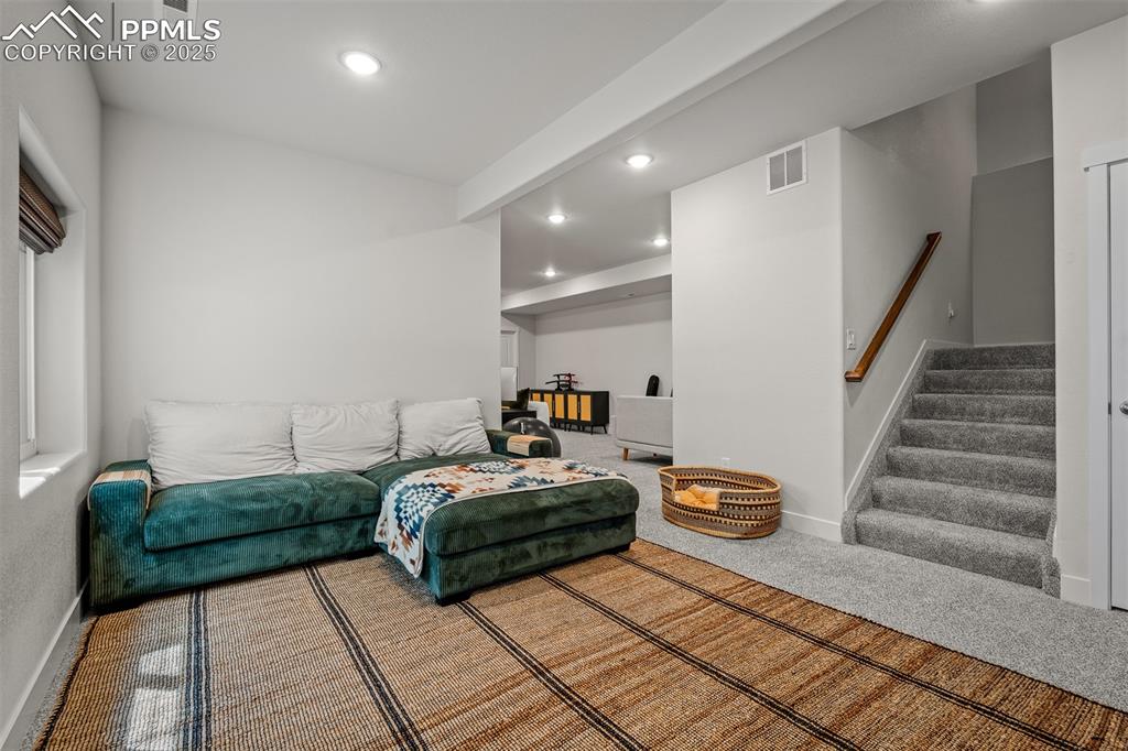 Image 39 of 49: Living room featuring recessed lighting, stairs, baseboards, and carpet flo