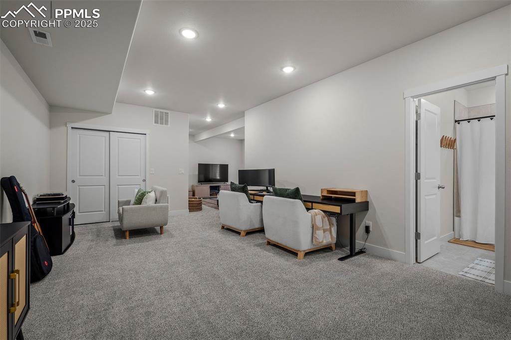 Image 42 of 49: Carpeted living area featuring recessed lighting and baseboards