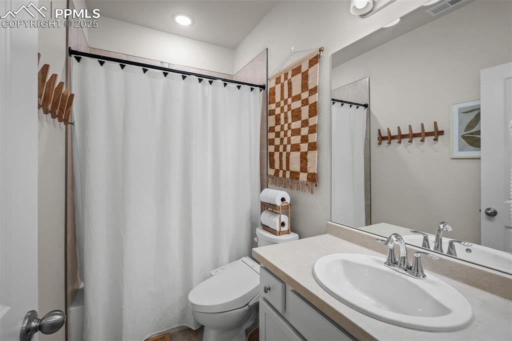 Image 43 of 49: Bathroom with toilet and vanity