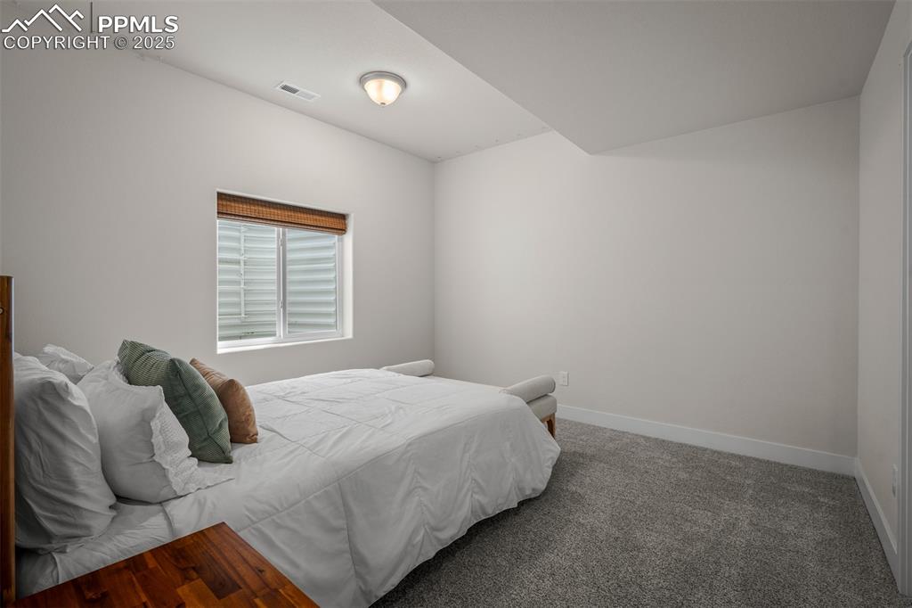 Image 44 of 49: Carpeted bedroom featuring baseboards
