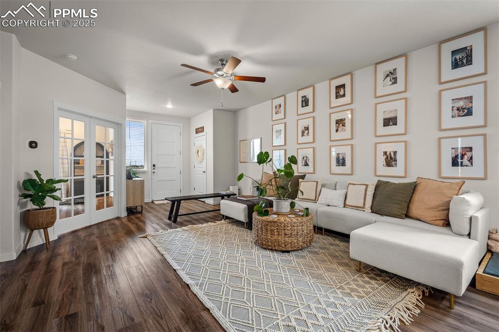 Image 6 of 49: Living room featuring a ceiling fan, wood finished floors, baseboards, fren