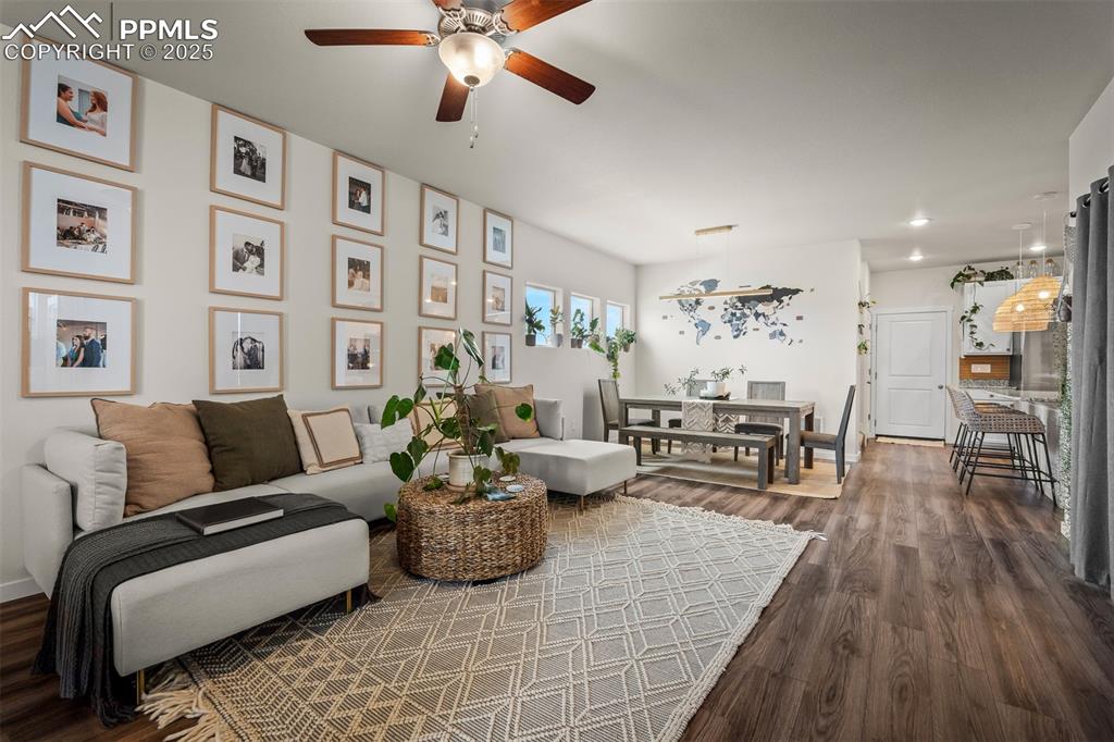 Image 7 of 49: Living room with a ceiling fan, dark wood-style floors, recessed lighting, 