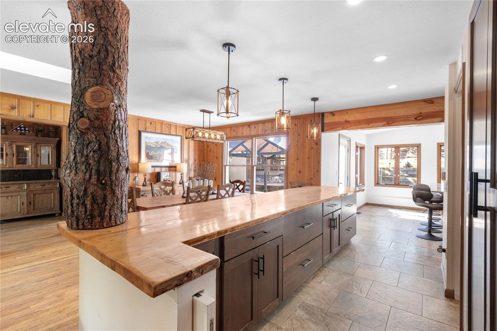 Image 19 of 50: Live Edge Counter w/ Custom Covered Tree Trunk Support Beam