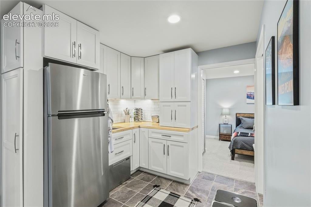 Image 41 of 50: Downstairs Kitchenette w/ Dishwasher, Fridge, Coffee Garage, Heated Floors 