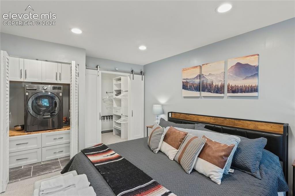 Image 42 of 50: Bedroom w/ a 1-Unit Washer/Dryer & Walk-in Closet w/ Additional Storage
