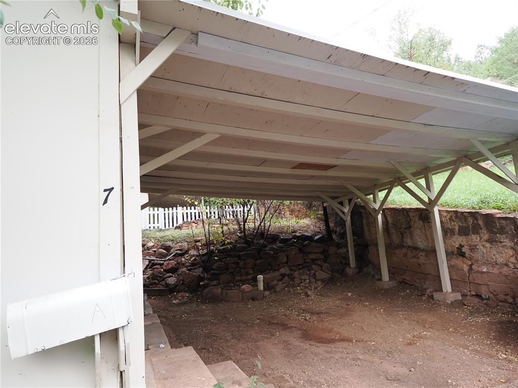 Image 33 of 44: carport and street parking in front of the cottage 