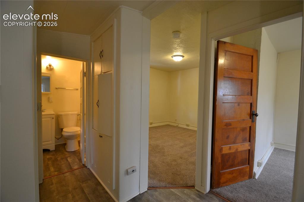 Image 4 of 18: Hallway to bathroom, living room, and bedroom