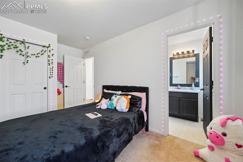 Image 17 of 43: Carpeted bedroom featuring white walls and white paneled doors