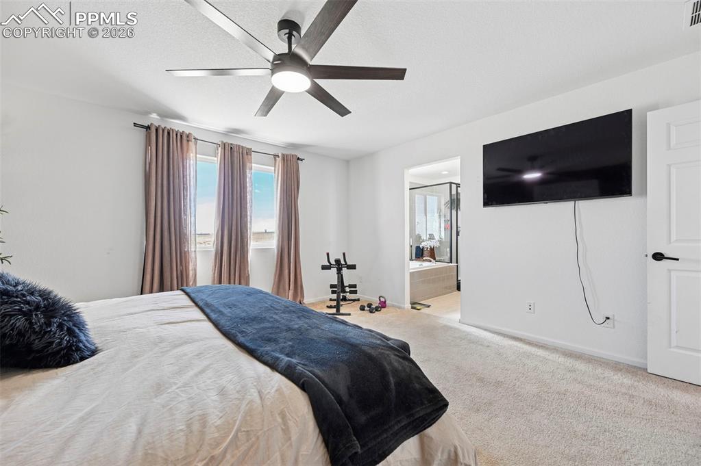 Image 18 of 43: Carpeted bedroom featuring a contemporary ceiling fan with lighting, three
