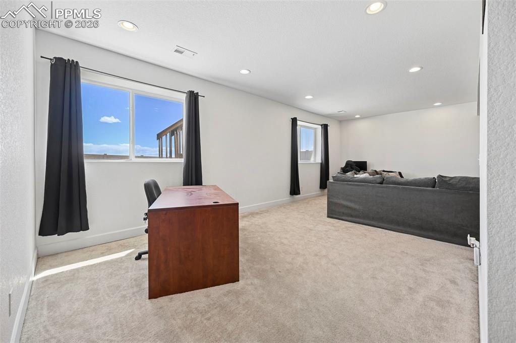 Image 29 of 43: Spacious room featuring light-colored carpeting and recessed lighting